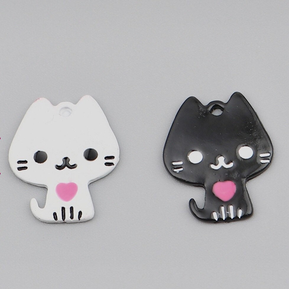 White cat charm. painted metal cat with heart, back is white